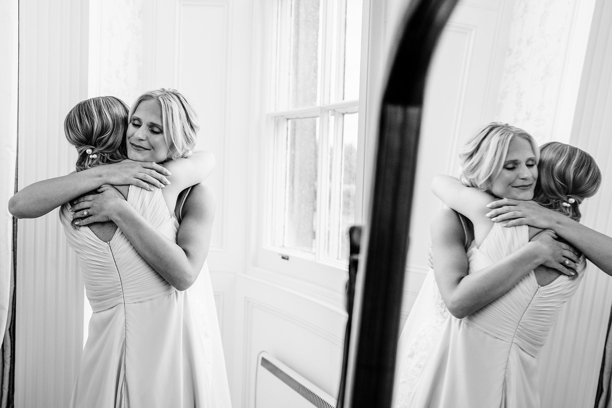 bride hugs her sister during candid wedding photography moment