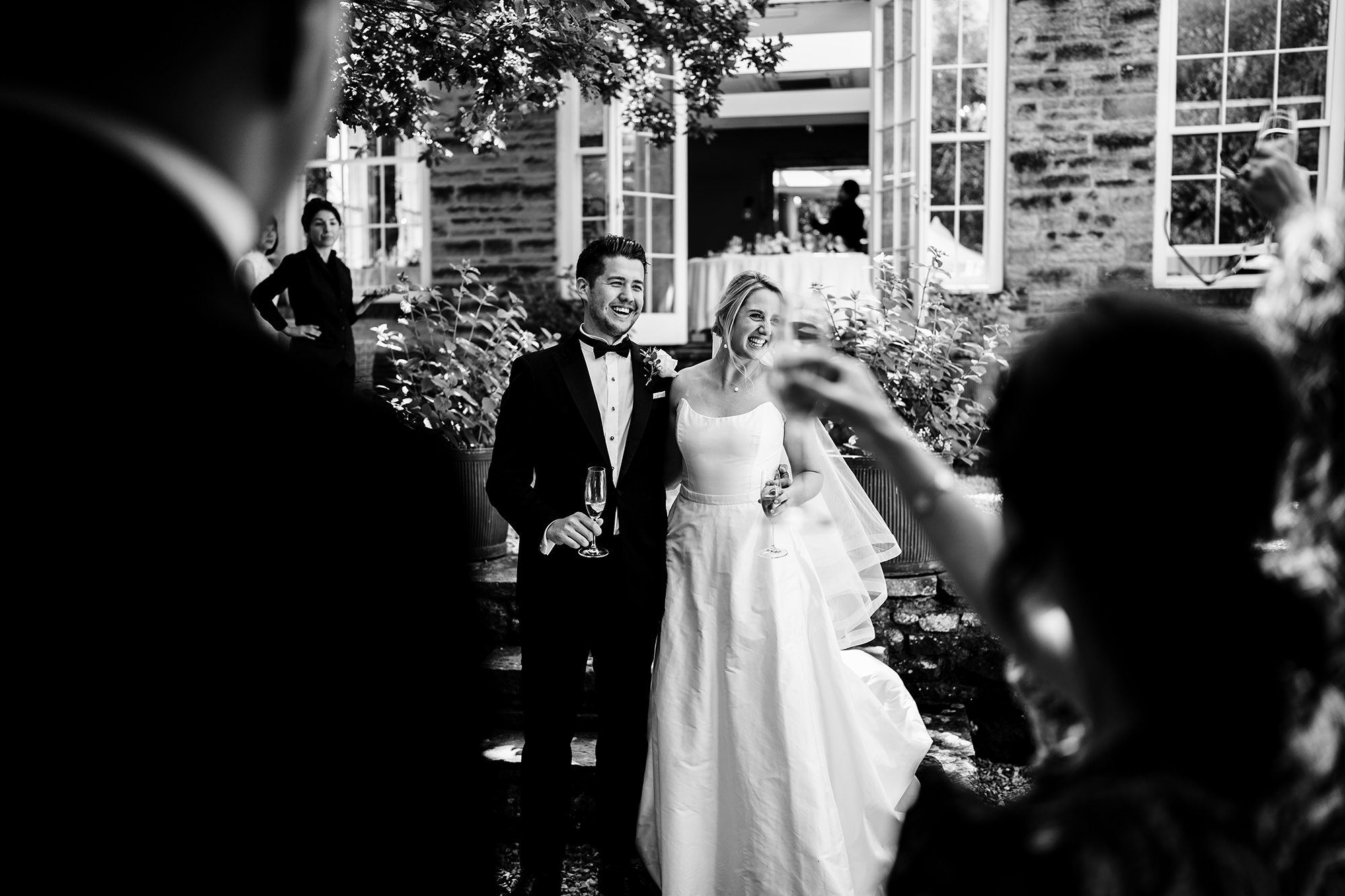 candid photograph of couple though wedding guests in yorkshire