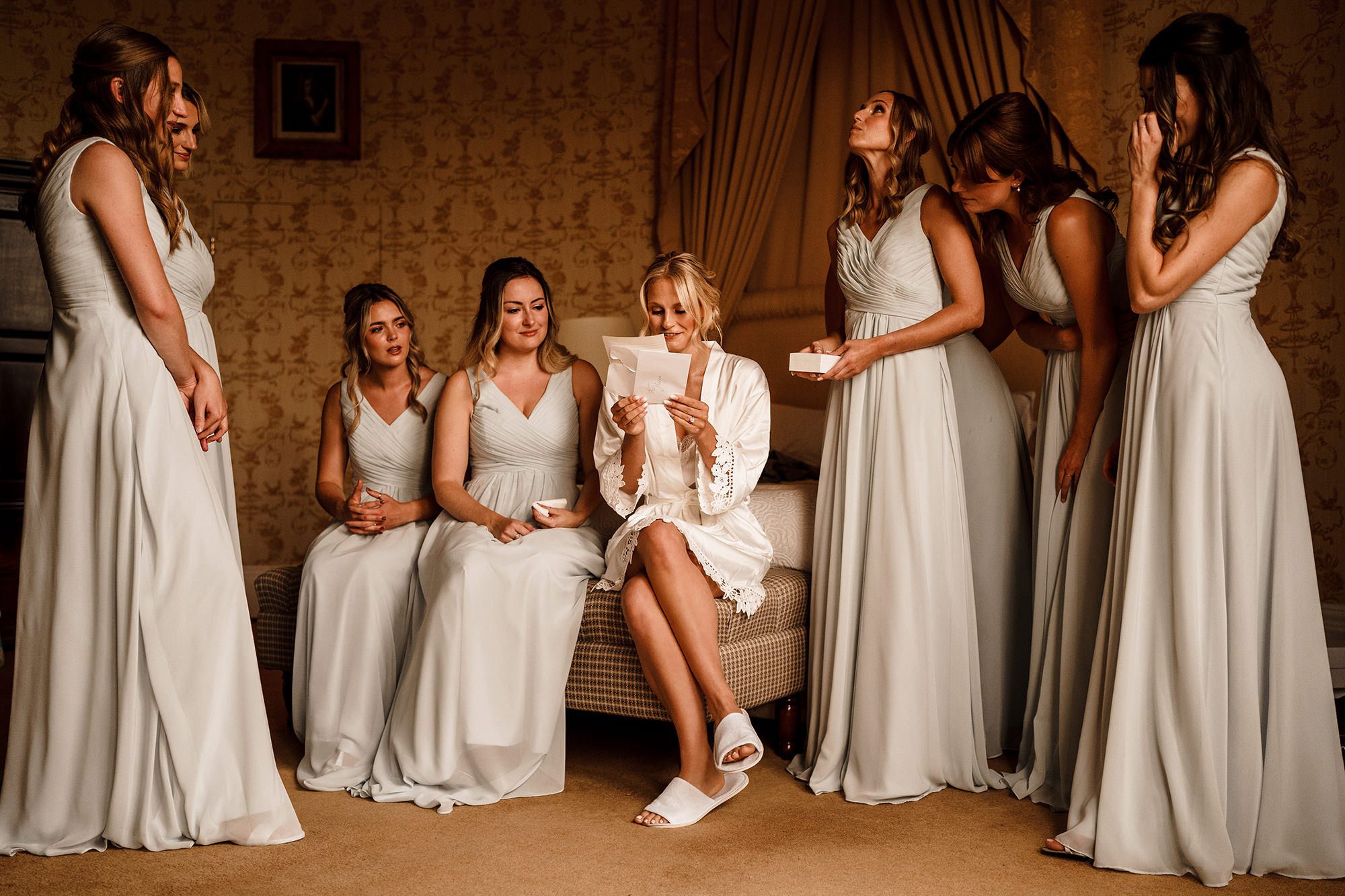 bridesmaids at wedding surrounding a bride