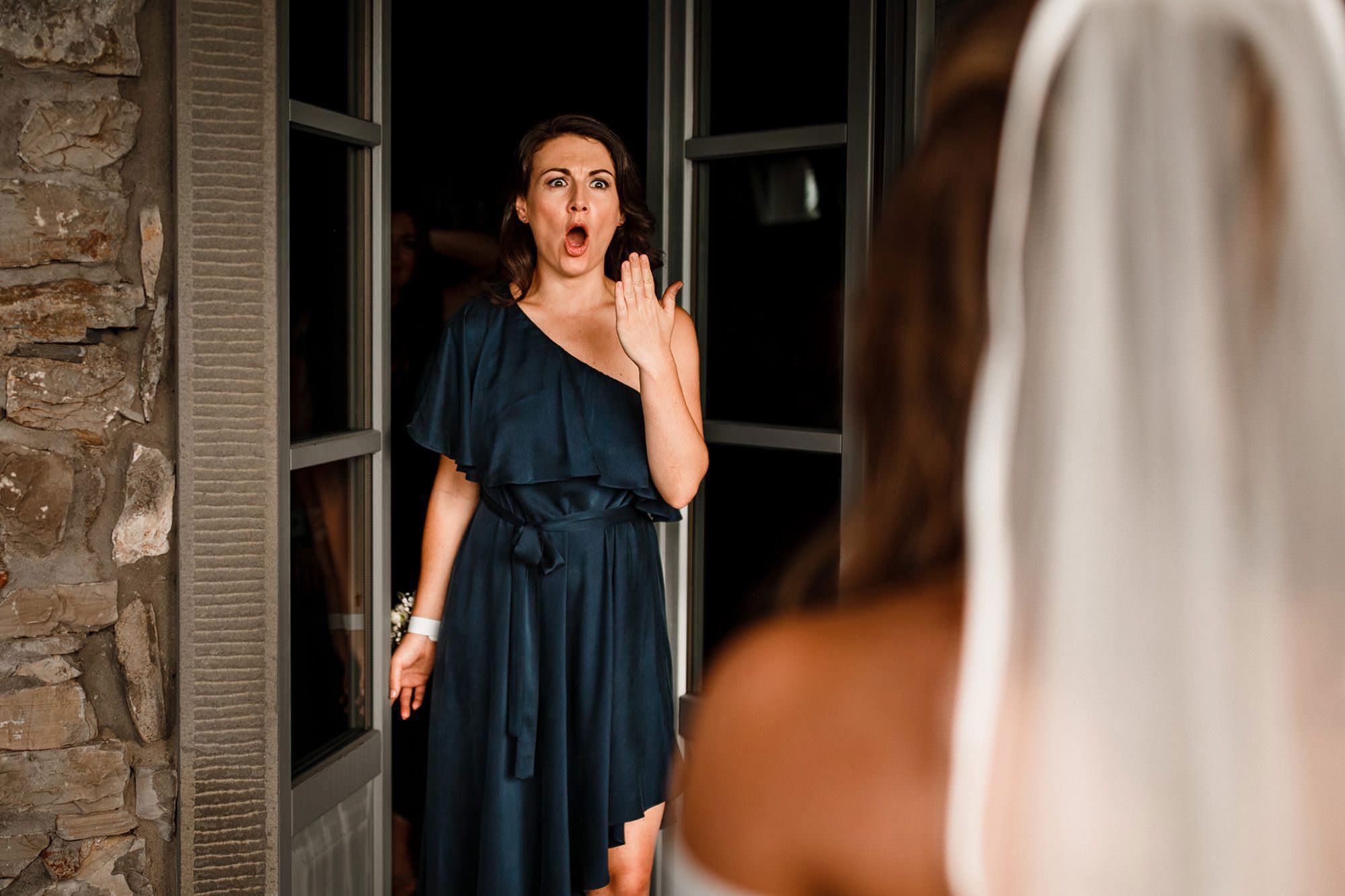 perfect candid moment of bridesmaid looking at bride