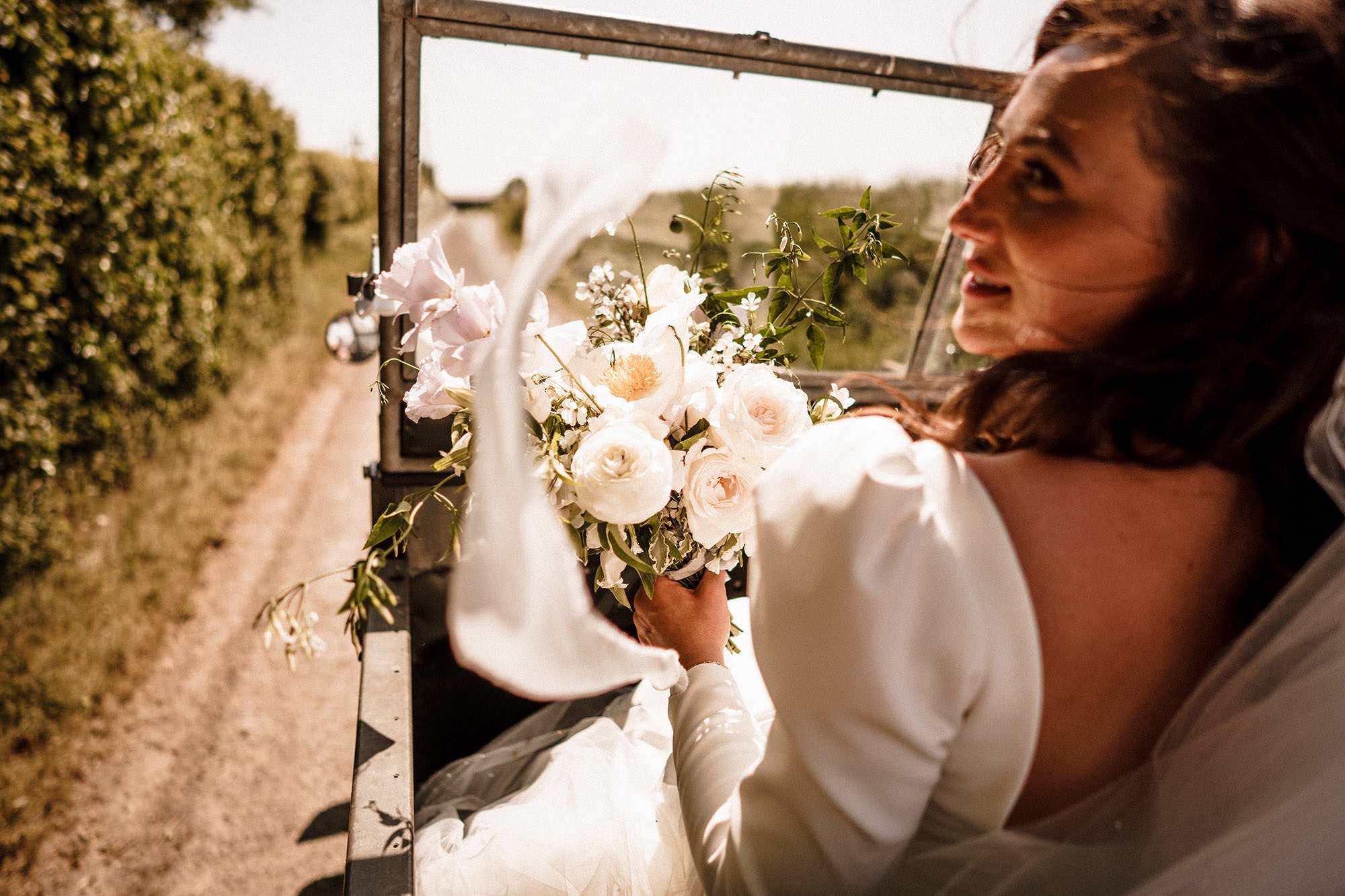 bride in wedding car at her tuscan wedding